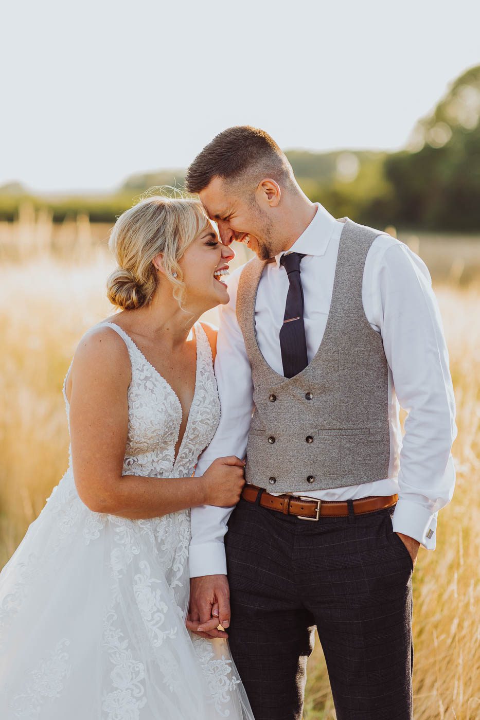 yorkshire wedding photographer | relaxed photo of happy bride and groom in field at golden hour