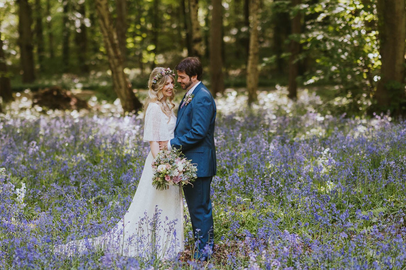 hazlewood castle wedding photography | relaxed photo of bride and groom in bluebell woods at hazlewood castle in yorkshire