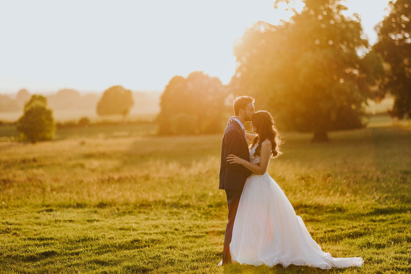 newby hall wedding photos | romantic photo of bride and groom during golden hour in the countryside at newby hall in north yorkshire. stately home wedding near harrogate